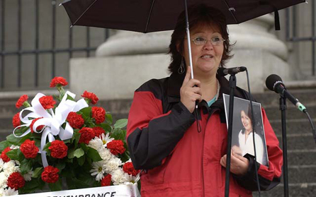 Sandra Gagnon holds a photo of her missing sister, Janet Henry, in this 2004 file photo. PHOTO: Ian Smith, Vancouver Sun files.