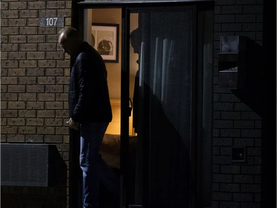 Det. Dan Duiker and Det. Shane Darda leave a motel room as members of the EPS Human Trafficking and Exploitation unit...