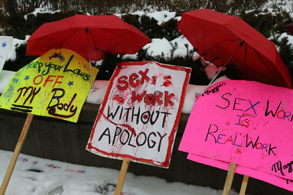 Signs from a Toronto sex work rally.
