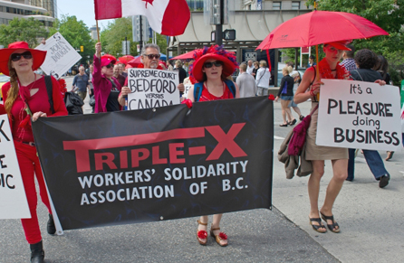 Sex trade workers and supporters walk along Robson Street during a rally and march June 8, 2013 ahead of a landmark court case next week challenging Canada's prostitution laws. PHOTO: Arlen Redekop, Png, The Province.