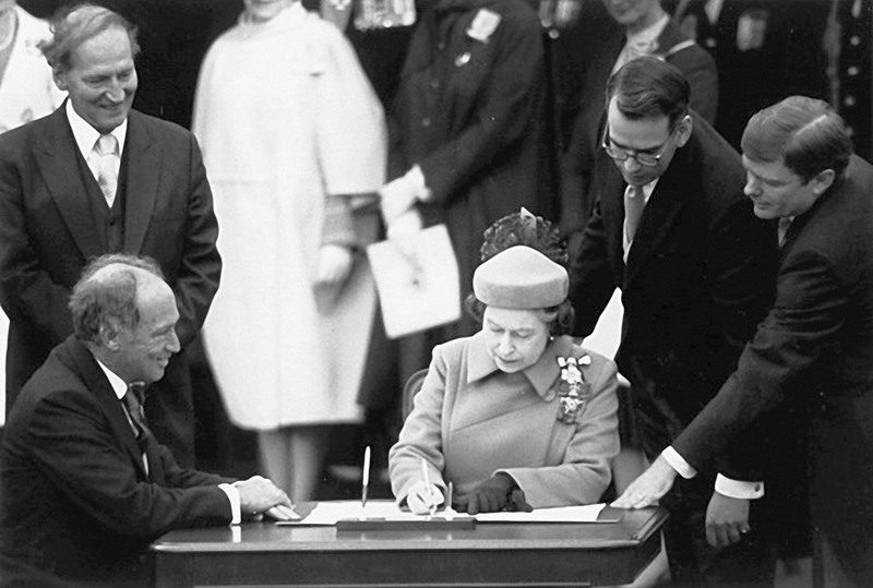 Her Majesty Queen Elizabeth II signs Canada's new Charter of Rights and Freedoms into law, April 17, 1982. PHOTO: National Archives of Canada