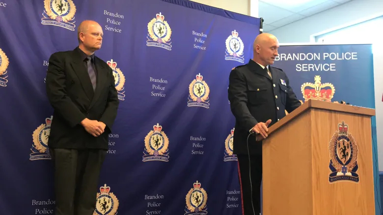 Winnipeg police Sgt. Richard McDougall, left, and Brandon police Insp. Mike Pelechaty speak about their joint counter-exploitation investigation, which resulted in 20 arrests and 15 vehicles seizures in two days. (Riley Laychuk/CBC